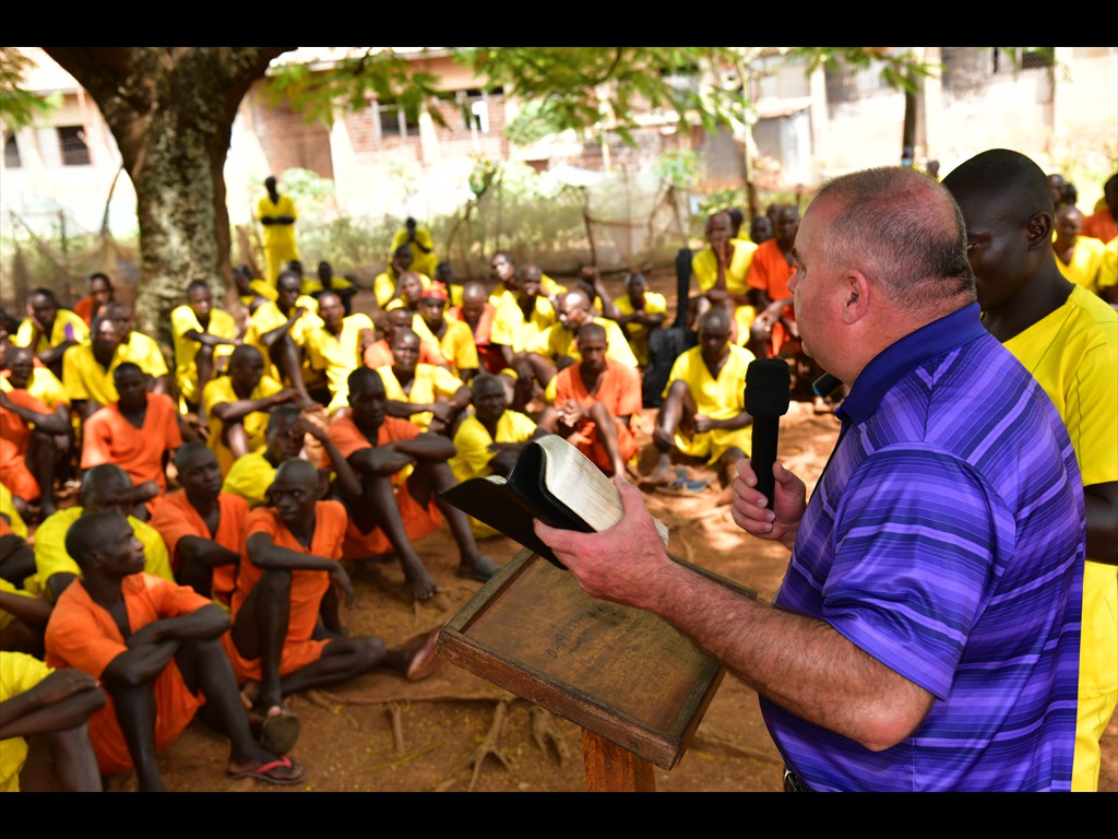 Pastor Joel preaching the Gospel in a large prison