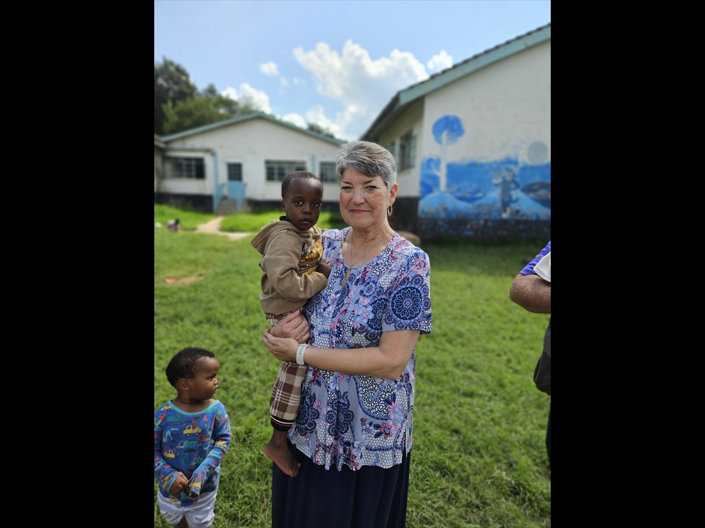 Sister Mildred Catron sharing the love of Jesus with one of the orphans at a children's rescue center.